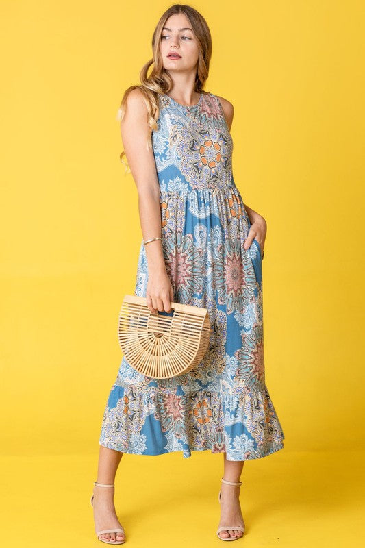 Woman wearing a floral dress holding a bamboo handbag against a yellow background