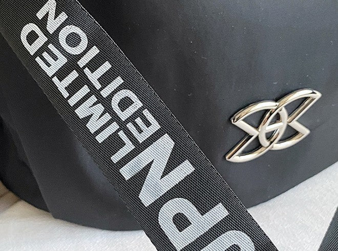 Black bag with a strap displaying 'Super Limited Edition' and a gold logo.