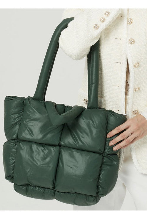Green puffer bag held by a person wearing Women’s Puffer Tote Handbag – Lightweight Quilted Shoulder Bag for Everyday Use
