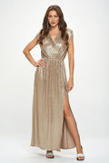 Woman wearing a metallic gold dress with a slit on a white background
