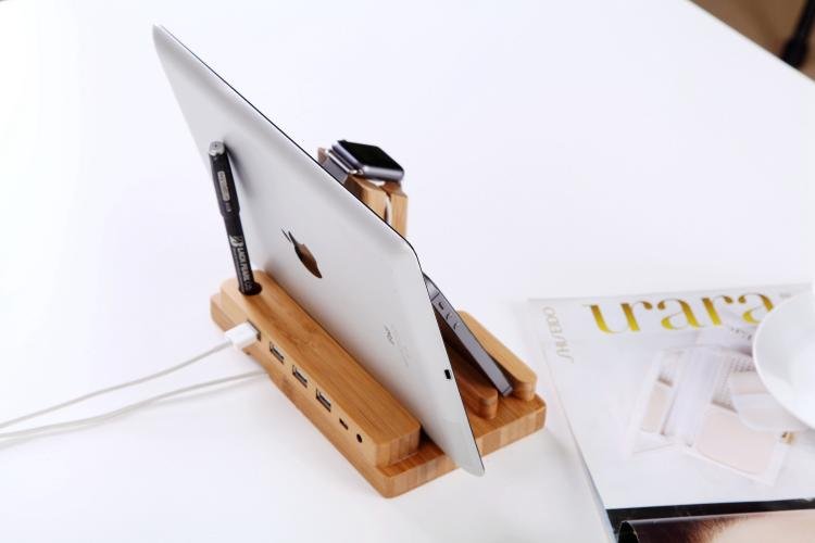 Wooden desk organizer with tablet stand, pen holder, and USB hub on a white surface.