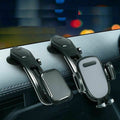 Three car phone holders on a car dashboard with a blurred cityscape background