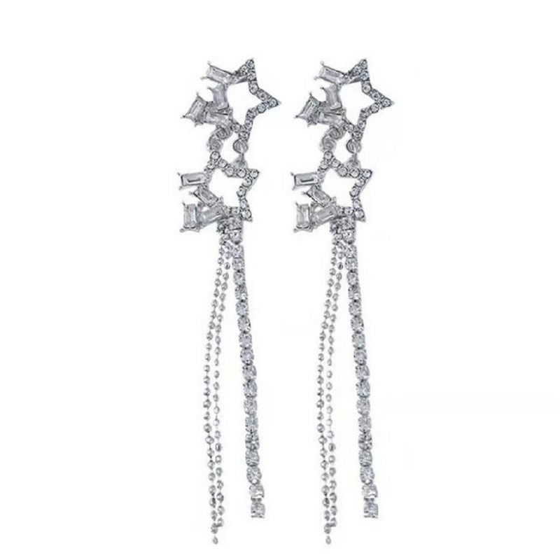 Pair of silver star-shaped earrings with dangling chains