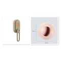 Beige grooming brush with orange button and pink pet toy on a white background