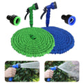 Green and blue expandable garden hose with nozzles on a white background