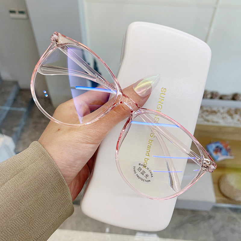Clear glasses held by a hand 