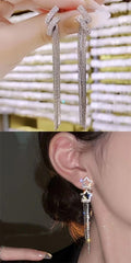 Elegant diamond earrings being worn, with a close-up of the earring on an ear.