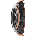 Close-up of a watch with a black case and rose gold accents