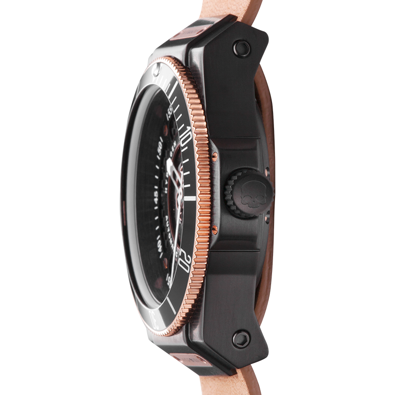 Close-up of a watch with a black case and rose gold accents