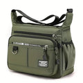 Green shoulder bag with multiple zippers