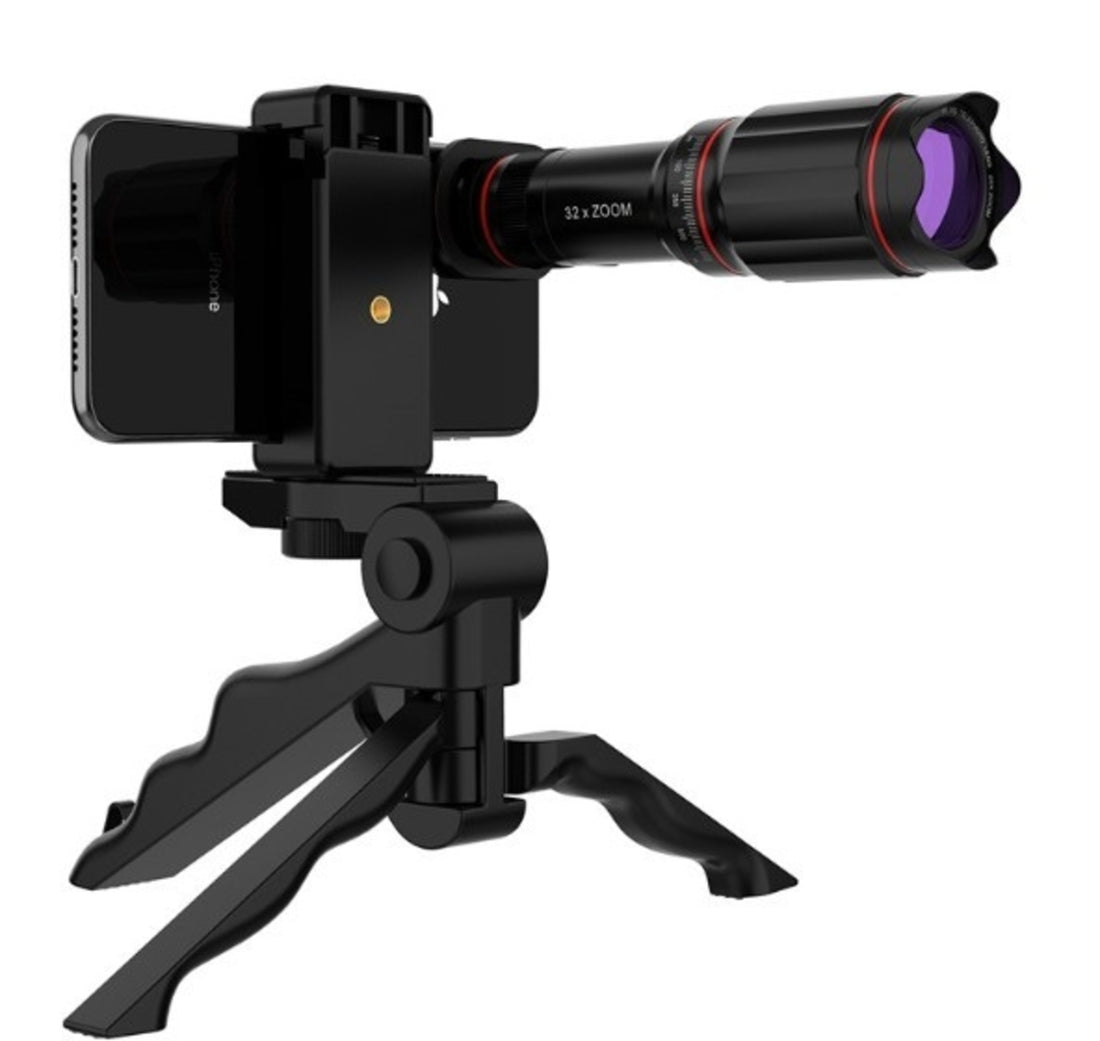 Phone with a telescope attachment on a tripod against