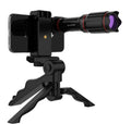 Phone with a telescope attachment on a tripod against