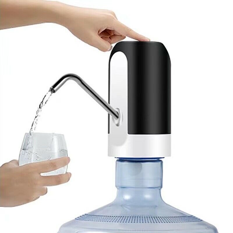Hand filling a glass with water from a black and white water dispenser.