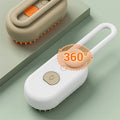 White handheld device with a handle and beige base on a light green background