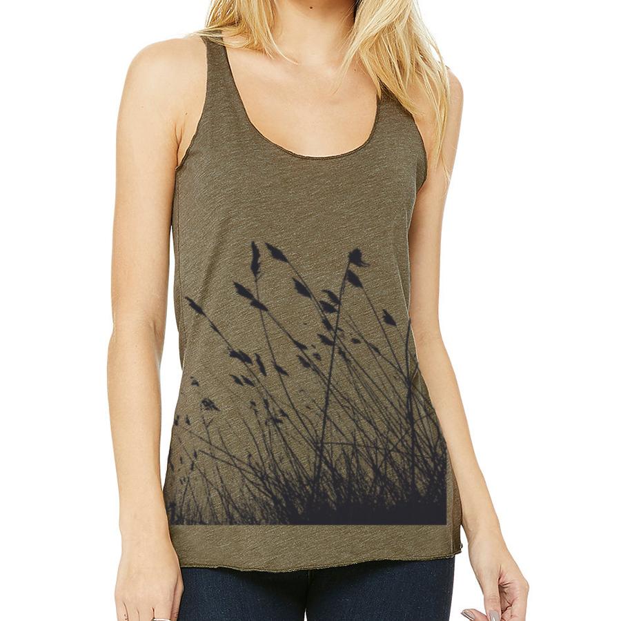 Woman wearing a green tank top with a black floral pattern